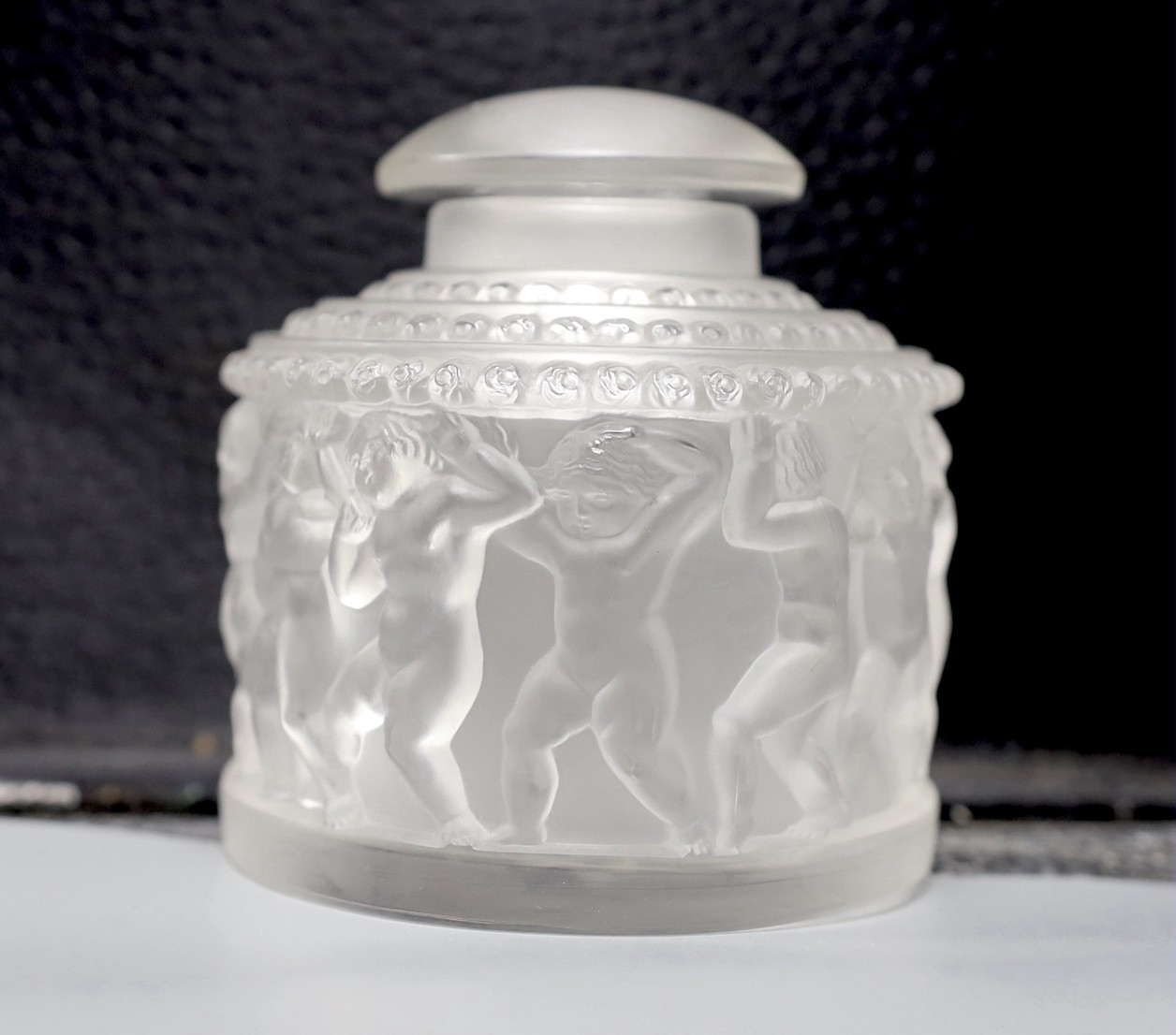 A Lalique Les Enfants pattern glass jar and cover. 30cm tall